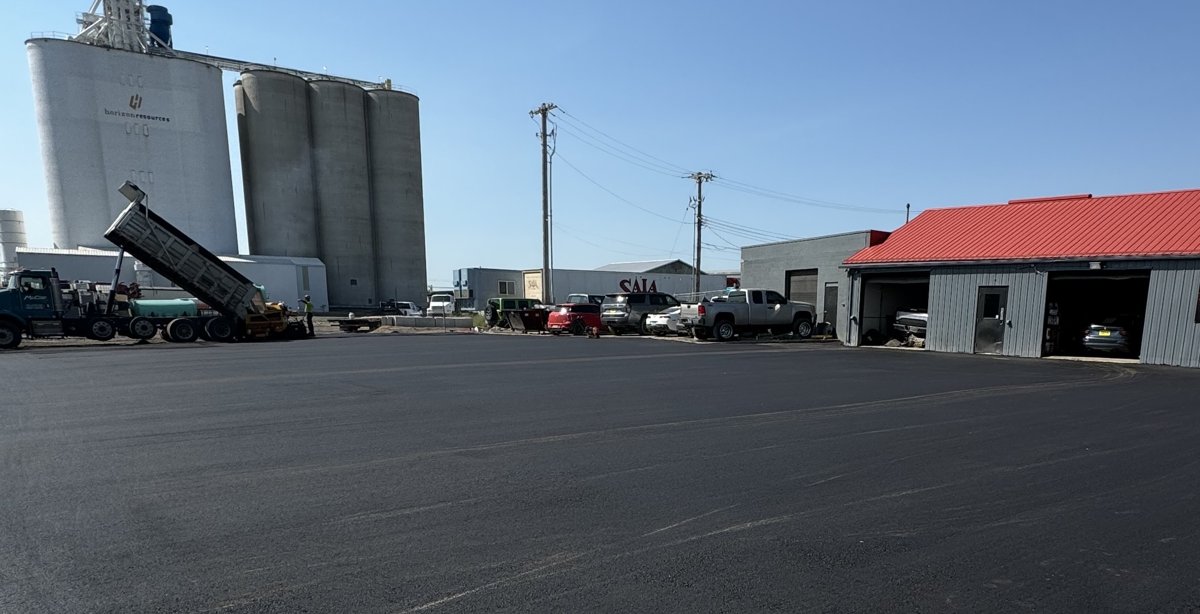 Commercial asphalt lot beside a grain elevator in Williston, ND