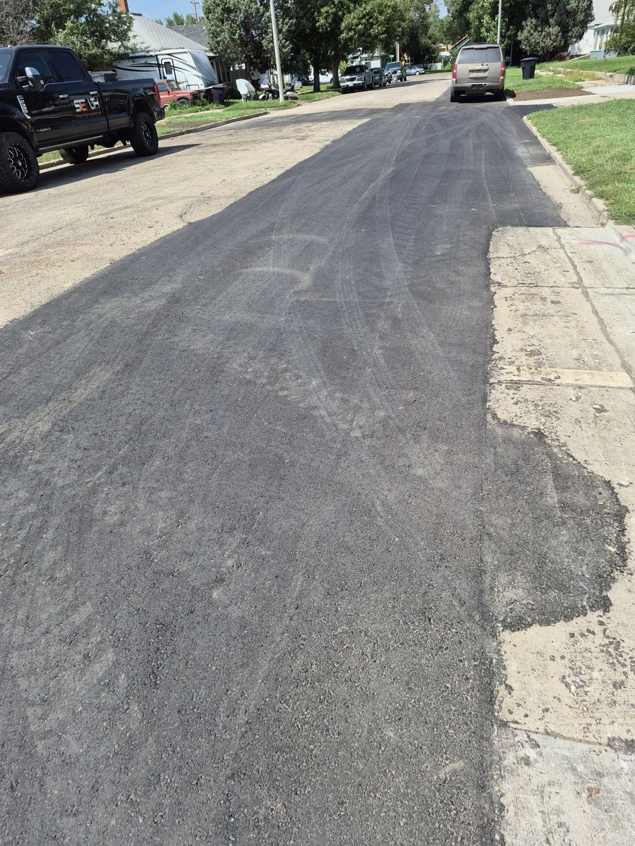 Asphalt overlay on a rural street in the Bakken region