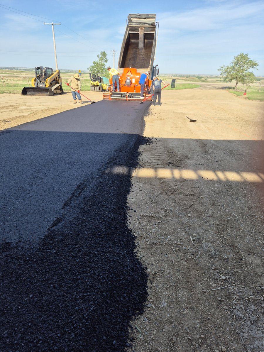 Asphalt paver laying a rural access road in the Bakken